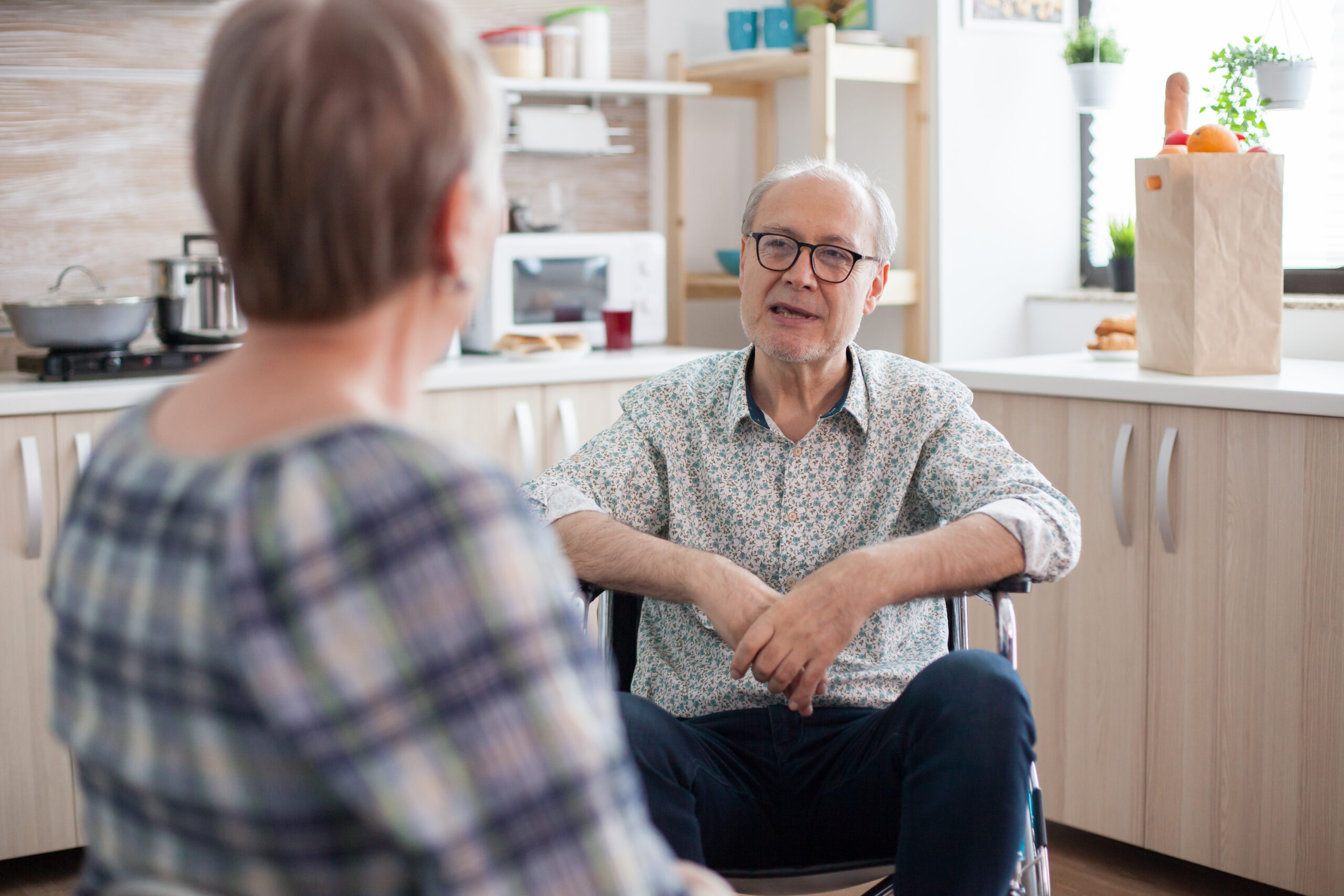 disabled senior man talking with wife